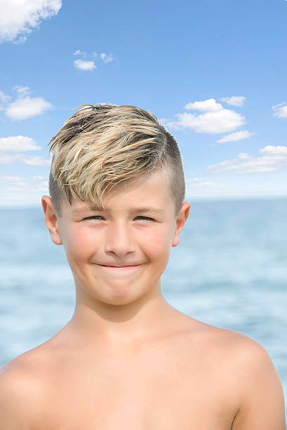 Seriesblond Ten Year Old Boy Making Funny Face By Ocean Stock Photo -  Download Image Now - iStock