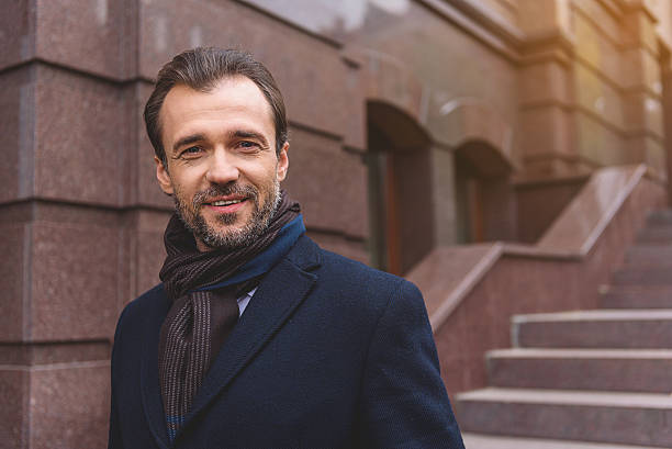 istock Joyful businessman waiting on staircase 627350082