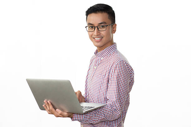 istock Smiling Asian man with pc looking at camera 627352522