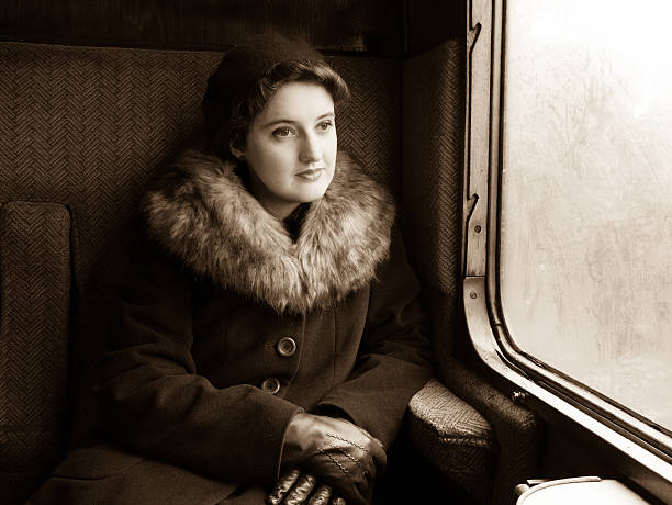 Sepia tinted capture of a 1940's re-enactor in a steam train compartment