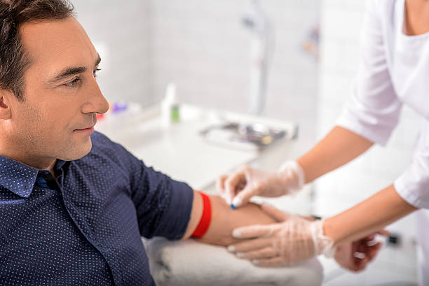 male patient having blood sampling - senior adult human face male action imagens e fotografias de stock