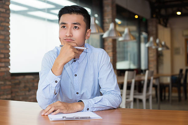 istock Asian Entrepreneur Thinking on Project in Cafe 627355984