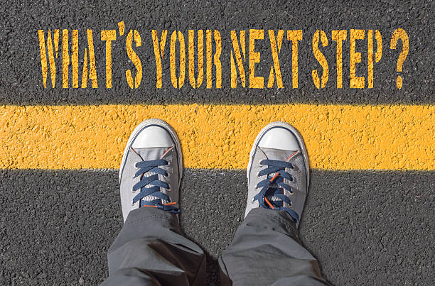 istock What`s your next step?, print with sneakers on asphalt road 627356104