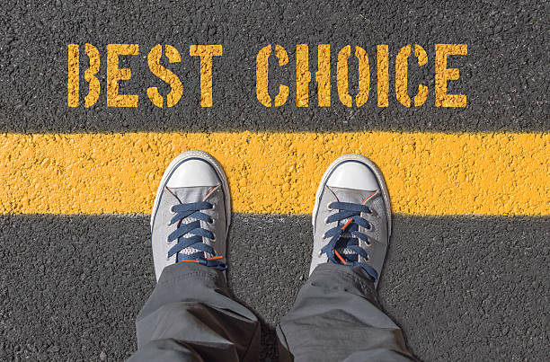 istock Best choice, print with sneakers on asphalt road. 627356208