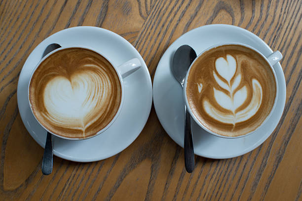 istock Coffee with heart pattern in white cup on wooden  background, 627356748