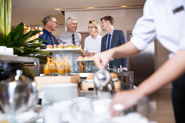istock Four Smiling Business People at Buffet Table 627356802