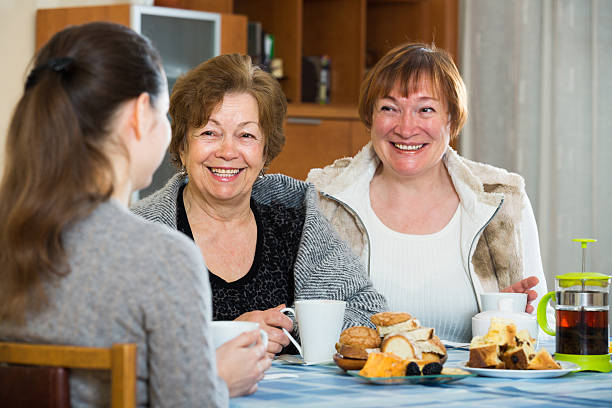 istock Young female and mature women drinking tea and talking 627357710