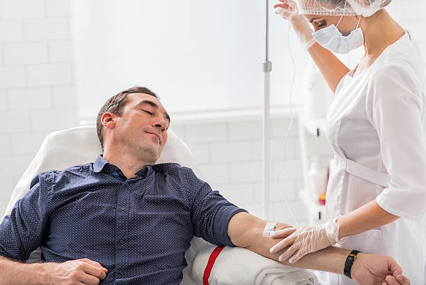 istock Calm male patient getting drip treatment 627357962