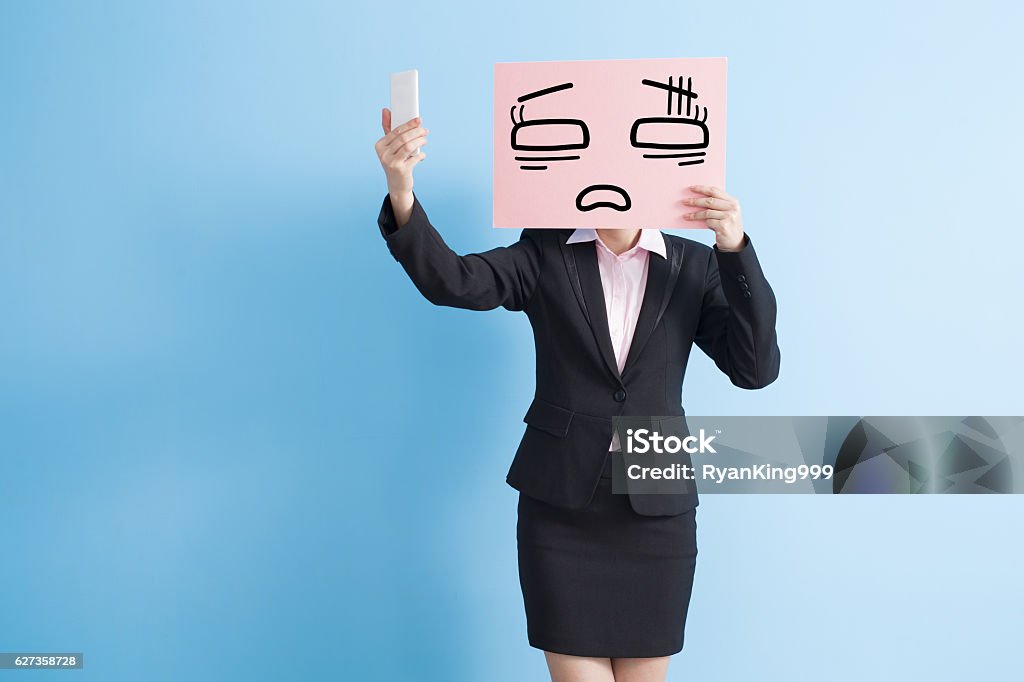 business woman take billboard business woman take tired billboard and selfie, isolated blue background Sadness Stock Photo