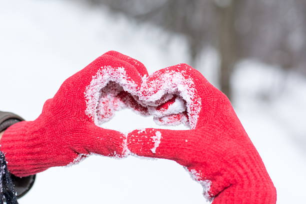 istock Making heart shape on winter day in red gloves 627364008