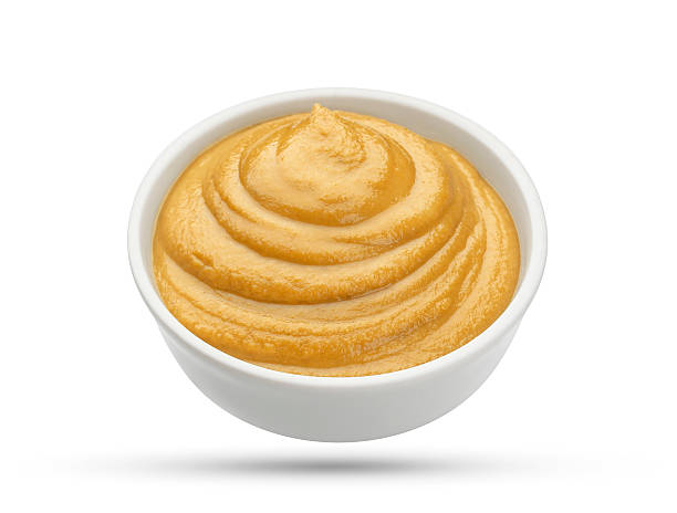 istock Mustard in bowl isolated on white background 627364414