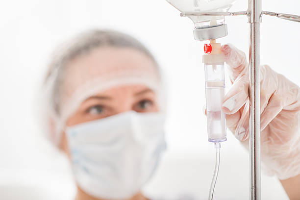 istock Serious medical worker putting dropper 627370540