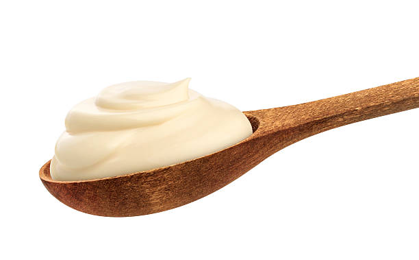 istock Sour cream in spoon isolated on white background 627370774