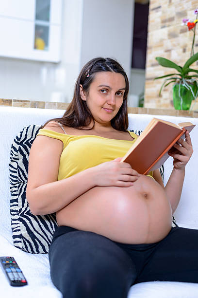 istock Single pregnant woman reading alone 627371628