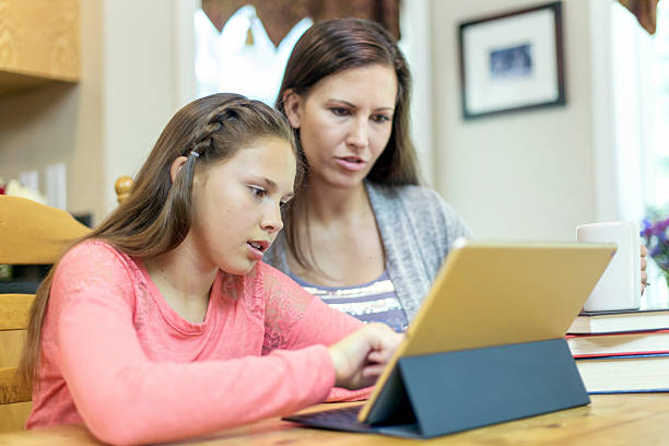 istock Young girl using smart tablet for homeschool homework 627371782
