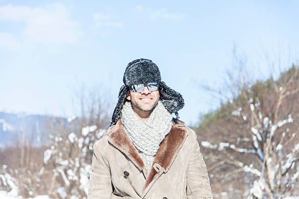 istock Smiling young man resting in the snow 627372236