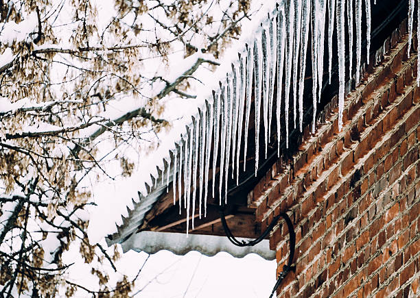 istock Winter beauty. Old brick house and icicles 627373482