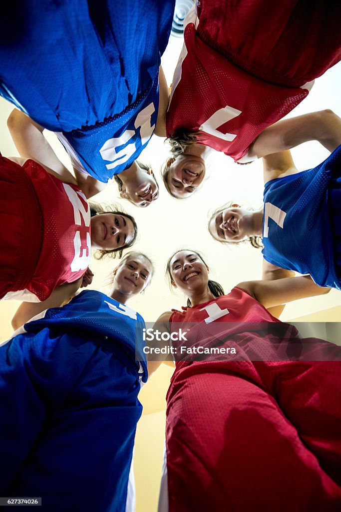 Multi-ethnic female high school basketball team during a huddle High School Stock Photo