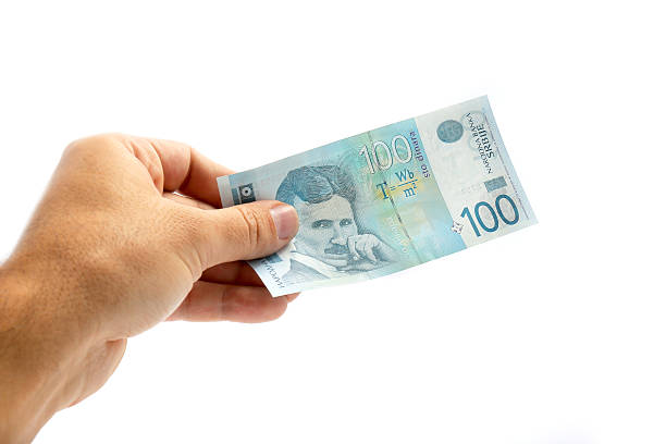 istock male hand holding serbian 100 dinar banknote on white background 627380624