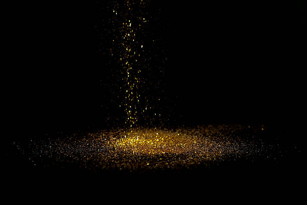 istock Sprinkle gold dust on a black background with copy space. 627380972