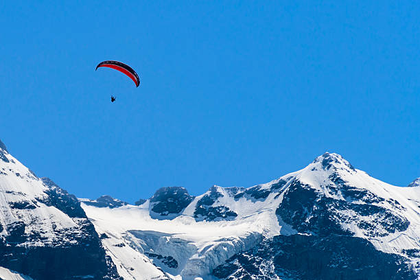 istock Paragliding over snow capped mountains 627391538
