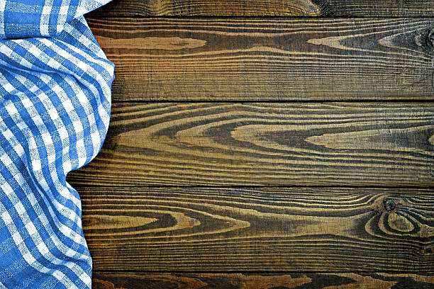 istock Blue checkered napkin on wooden table 627397412