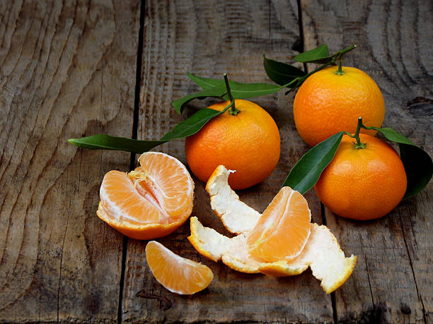 istock ripe tangerine on a wooden background. selective focus 627397420