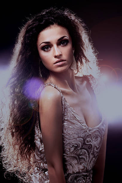 istock Young dancing woman, with flashes on background 627398410