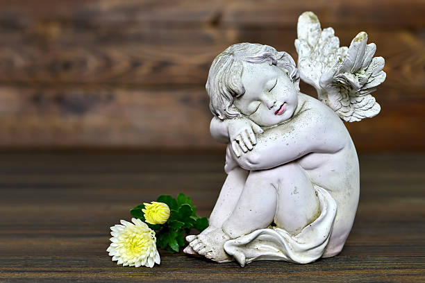 istock Angel and flowers 627399544