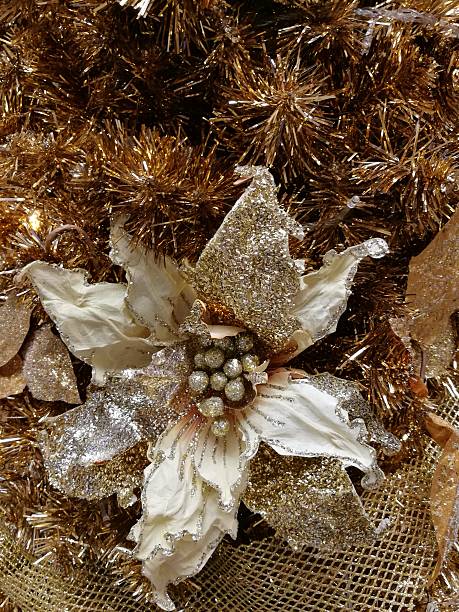 istock Embellished Christmas tree decoration gold flower and tinsel 627400456