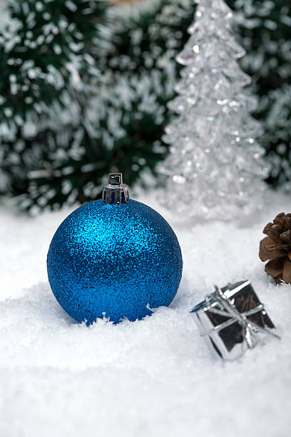 istock Christmas background with a blue ornament, golden gift on snow 627401036