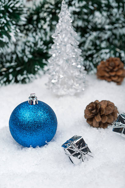 istock Christmas background with a blue ornament, golden gift on snow 627401186