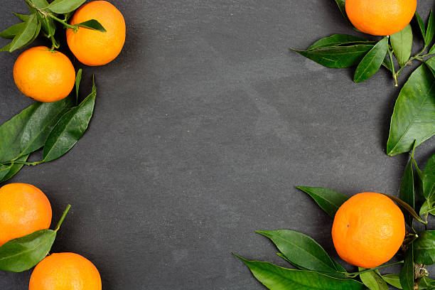 istock Tangerine fruits on dark table 627401762