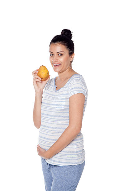 istock Pregnant woman eating pear 627401856