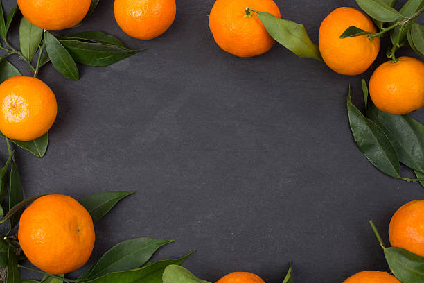 istock Tangerine fruits on dark table 627402014