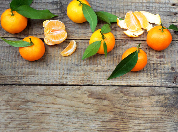 istock ripe tangerine on a wooden background. selective focus. copy space 627402072