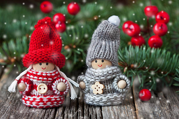 istock Small children christmas   figures on wooden background 627402236