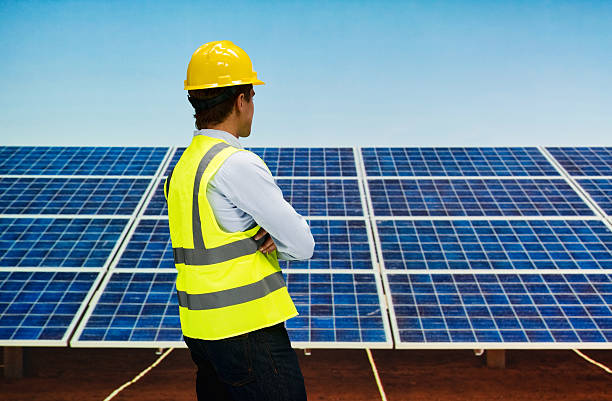 istock Rear view of solar worker standing outdoors 627416362