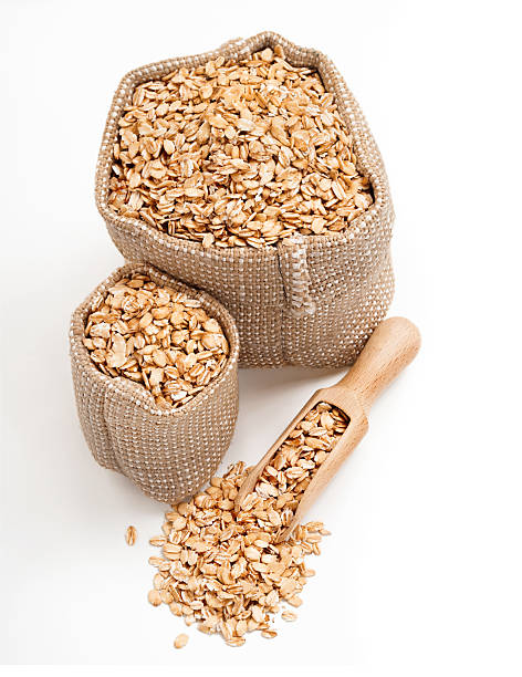 istock Oatmeal in burlap sack with wooden spoon 627416994