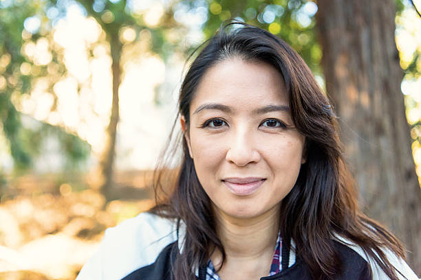 istock Smiling asian woman looking at the camera 627417008