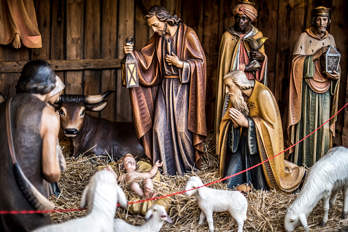 Bolzano, Italy, UE – November 27, 2016: wooden Nativity Scene being displayed during traditional Italian Christmas Market in South Tyrol during its debut day.