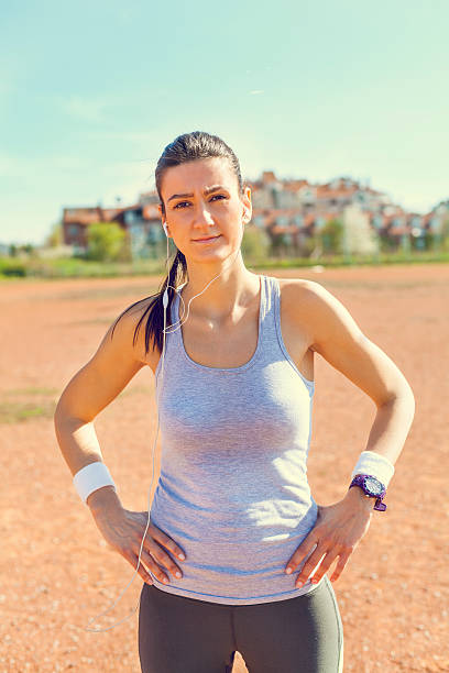Young sportswoman stretching before running