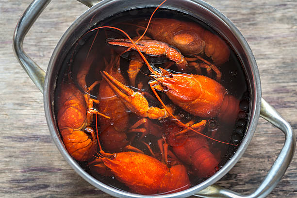 istock Pot with boiled crayfish on the wooden table 627428666