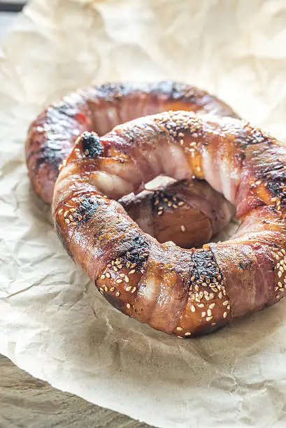 Bagels with sesame wrapped in bacon rashers