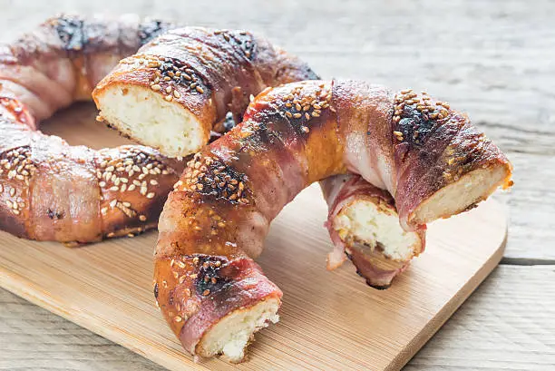 Bagels with sesame wrapped in bacon rashers