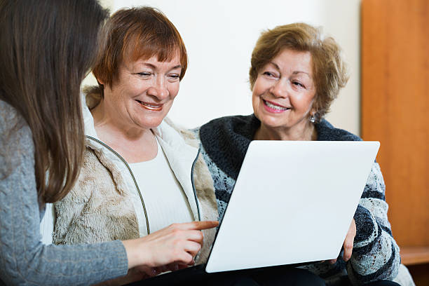 istock Female pensioners and relative browsing web on laptop 627429682