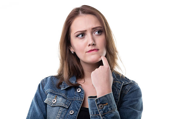 istock Puzzled young woman in jeans jacket 627430740