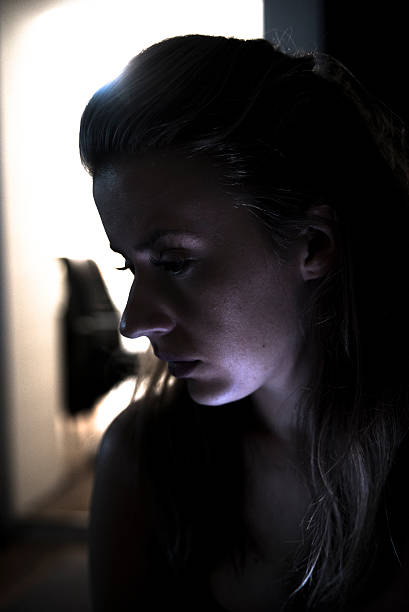 istock Insomnia, sad woman sitting in her room alone 627431456