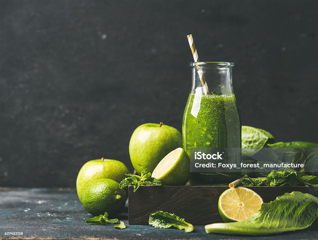 Smoothie with apple, romaine lettuce, lime and mint, copy space Green smoothie with apple, romaine lettuce, lime and mint, dark blue background, selective focus, copy space. Detox, dieting, clean eating, vegetarian, vegan, fitness diet or healthy lifestyle concept Green Color Stock Photo