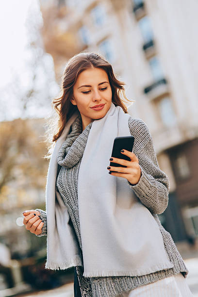 istock Young woman texting outdoors 627443564